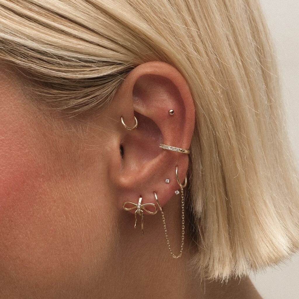 Cliff bow huggie earrings